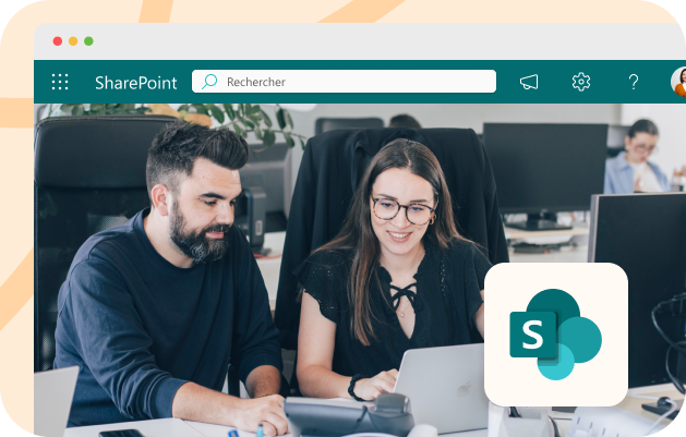 Deux chefs de projet en agence SharePoint travaillent devant un ordinateur.